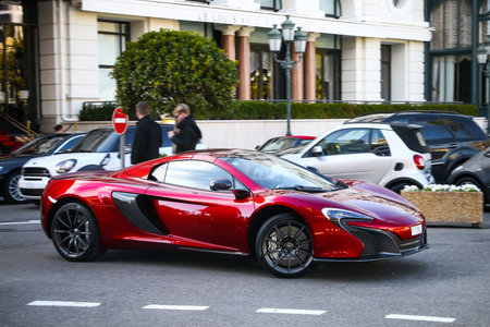 Monte-Carlo, Monaco - March 12, 2019: Red supercar McLaren 650S in the city street.のeditorial素材