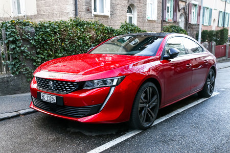 Bern, Switzerland - March 13, 2019: Red motor car Peugeot 508 in the city street.のeditorial素材