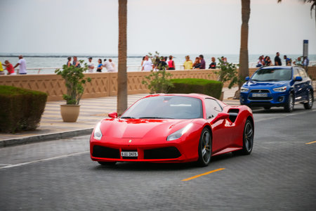Dubai, UAE - November 17, 2018: Red luxury sportscar Ferrari 488 in the city street.のeditorial素材