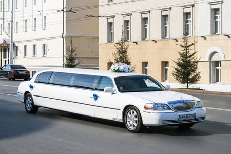 Ufa, Russia - September 12, 2009: White wedding stretch car Lincoln Town Car in the city street.のeditorial素材