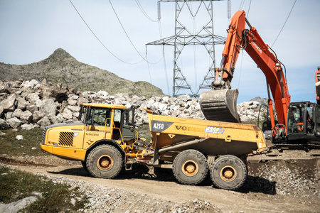 Saint Gotthard Pass, Switzerland - September 14, 2019: Yellow articulated dump truck Volvo A25D at...