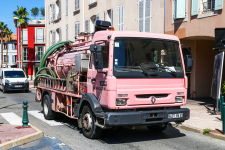 Saint-Tropez, France - September 11, 2019: Pink sanitary truck Renault Midliner in the city street.のeditorial素材