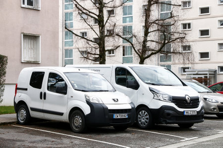 Annecy, France - March 13, 2019: White delivery vans Peugeot Bipper and Renault Trafic in the city street.のeditorial素材