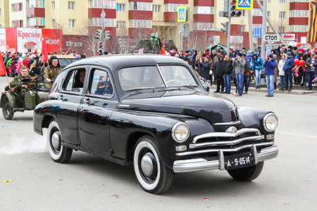 Novyy Urengoy, Russia - May 9, 2015: Soviet saloon car GAZ 20 Pobeda at the annual Victory Day parade.のeditorial素材