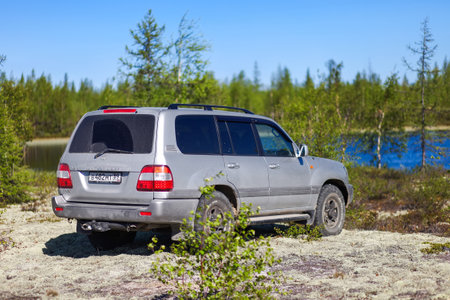 Novyy Urengoy, Russia - June 6, 2020: Offroad car Toyota Land Cruiser 100 at the forest near the lake.のeditorial素材
