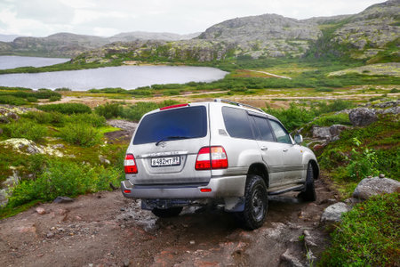 Teriberka, Russia - August 17, 2020: Expedition vehicle Toyota Land Cruiser 100 at the mountainous...