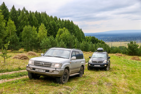 Asha, Russia - August 8, 2020: Offroad cars Toyota Land Cruiser in the woody Ural mountains.のeditorial素材