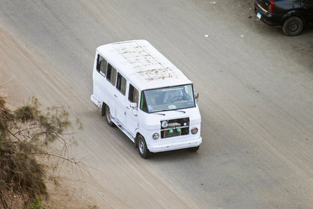 Giza, Egypt - January 26, 2021: Small city minibus Eltramco Ramzes in the city street.