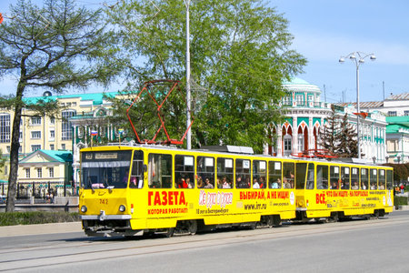 Ekaterinburg, Russia - May 8, 2010: Yellow double tramway Tatra T6B5 in the city street at the background of the Sevastyanov's House.のeditorial素材