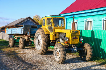 Ulu-Telyak, Russia - September 28, 2021: Bright yellow agricultural tractor T-40 in a village street.のeditorial素材