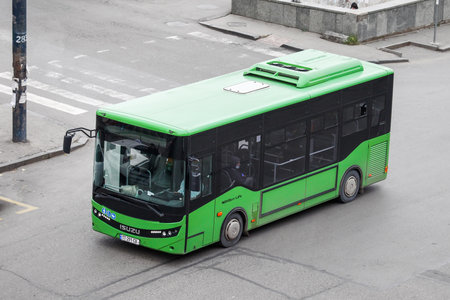 Tbilisi, Georgia - October 9, 2021: Green urban bus Anadolu Isuzu Novo Citi Life in a city street.のeditorial素材