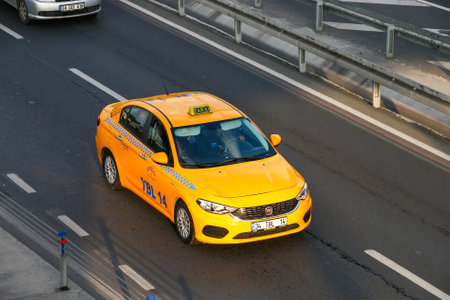 Istanbul, Turkey - October 12, 2021: Bright yellow taxi car Fiat Egea (Type 356) in a city street.のeditorial素材