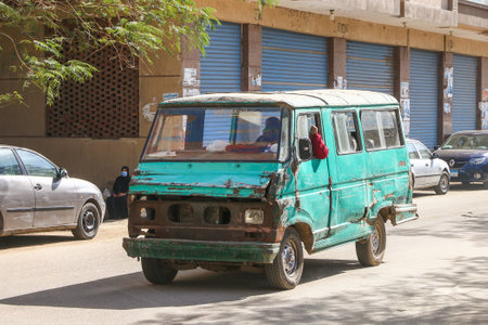 Giza, Egypt - January 26, 2021: Crumpled urban minibus Eltramco Ramzes in a city street.のeditorial素材