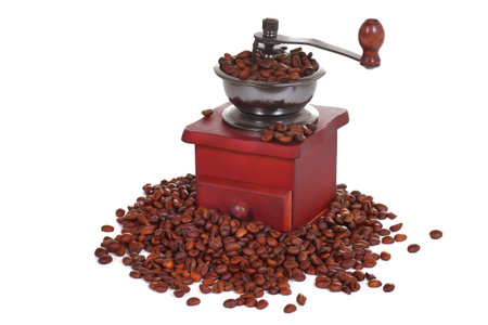 Manual coffee grinder in a heap of a coffee beansの写真素材
