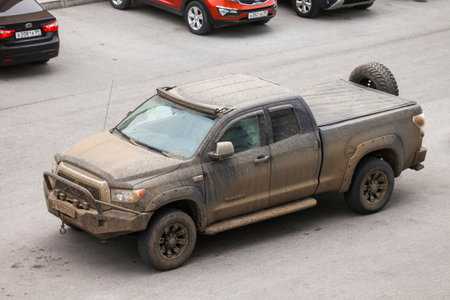 Novyy Urengoy, Russia - July 9, 2022: Dirty pickup truck Toyota Tundra in the city street.