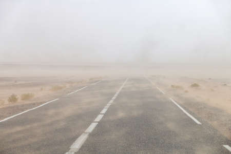Heavy sandstorm on the road through the Sahara desertの写真素材