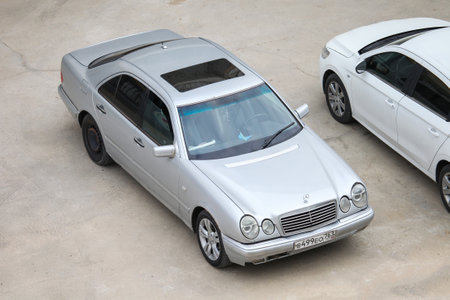 Atyrau, Kazakhstan - October 11, 2022: Silver saloon car Mercedes-Benz E-class (W210) in the city...