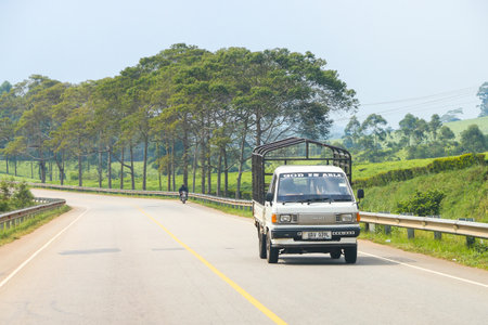 Western Region, Uganda - January 27, 2023: White compact truck Toyota TownAce at an intercity road.のeditorial素材