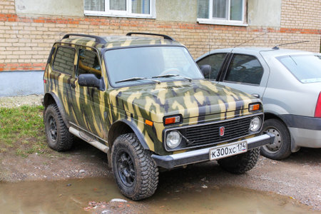 Asha, Russia - September 20, 2021: Camouflage painted offroad car Lada Niva Bronto in the city street.のeditorial素材