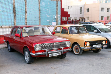 Novyy Urengoy, Russia - May 27, 2023: Vintage cars GAZ-24-10 Volga and Izh-Moskvich-412 in the city street.のeditorial素材