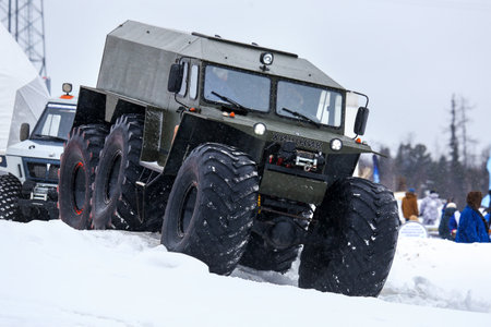 Tarko-Sale, Russia - March 2, 2024: Low-pressure tyres all-terrain vehicle Hishchnik-3930 (Predator) crossing the huge snowdrift.のeditorial素材
