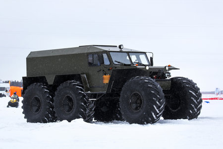 Tarko-Sale, Russia - March 2, 2024: Low-pressure tyres all-terrain vehicle Hishchnik-3930 (Predator) on the frozen river surface.のeditorial素材