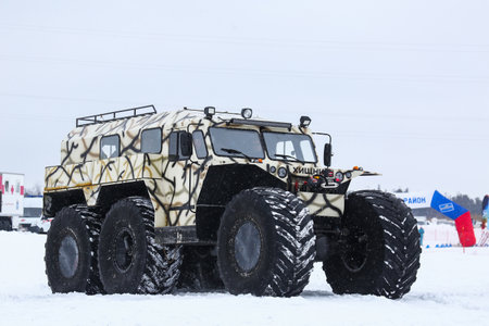 Tarko-Sale, Russia - March 2, 2024: Low-pressure tyres all-terrain vehicle Hishchnik-3930 (Predator) on the frozen river surface.のeditorial素材