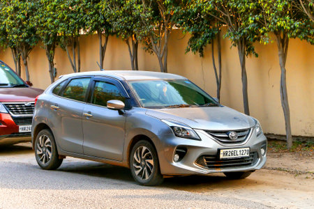 Gurgaon, India - March 3, 2022: Grey hatchback Maruti Suzuki Baleno in the city street.