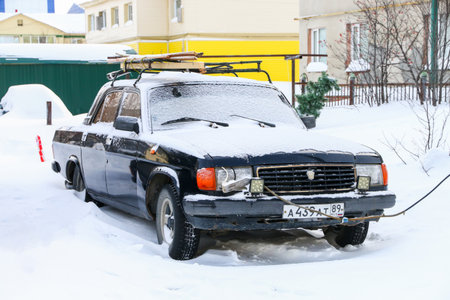 Pangody, Russia - February 24, 2024: Old saloon car GAZ-31029 Volga in the town street.のeditorial素材