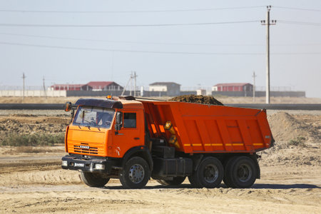 Atyrau, Kazakhstan - September 17, 2025: Old Russian tipper lorry Kamaz 65115 in the sand quarry.