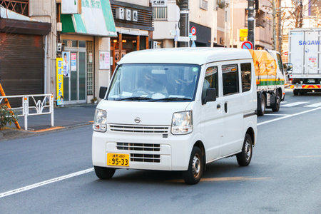 Tokyo, Japan - January 14, 2025: White urban kei van Nissan NV100 Clipper (DA17) in the city street.のeditorial素材