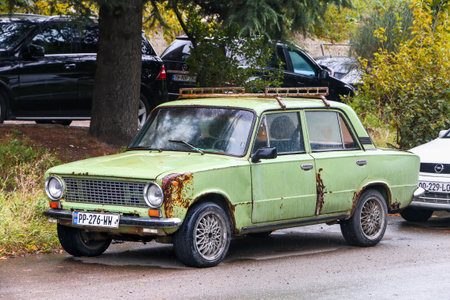Tbilisi, Georgia - September 19, 2025: Soviet rusty saloon car VAZ-2101 Zhiguli at the city street.のeditorial素材
