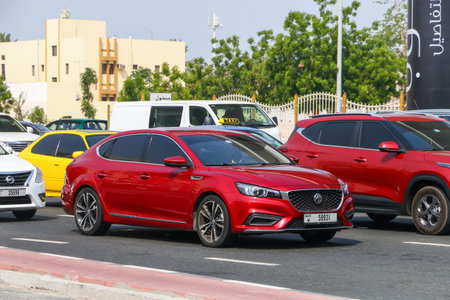 Dubai, UAE - July 3, 2024: Red compact saloon car MG 6 at the city street.