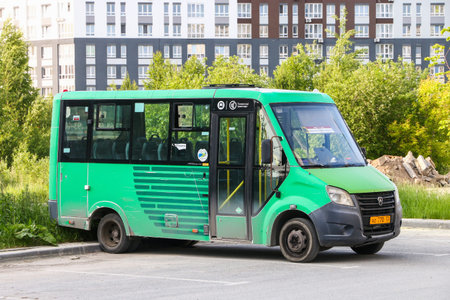 Tyumen, Russia - June 9, 2025: Small city bus GAZ-A64R45 Gazelle Next Citiline at the city street.のeditorial素材
