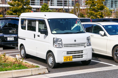 Tokyo, Japan - February 27, 2026: White kei van Suzuki Every (DA17) at the city street.
