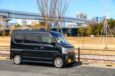 Tokyo, Japan - March 4, 2026: Black kei car Suzuki Every (DA17) at the city street.