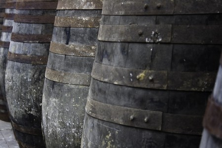Old wine barrels stored in rowsの写真素材