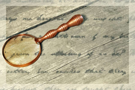 Retro Magnifying Glass and unrecognizable text on a wooden Board with gosted frame   Background with space for text or image の写真素材