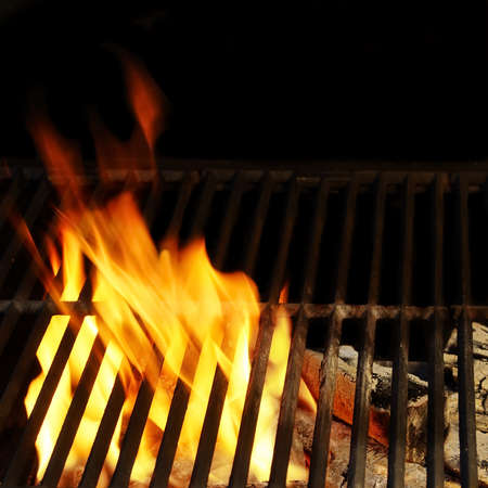 Hot BBQ Grill, Bright Flames ang Burning Coals. Background and Texture with space for text or image.