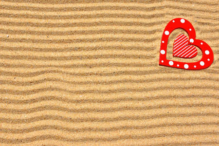 Two wooden love heart in the sea sand  Background with space for text or imageの写真素材