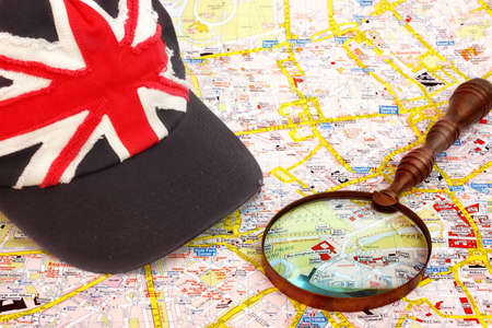 Map of London, magnifier glass and cap with British flag.  Buckingham palace Close-up.のeditorial素材