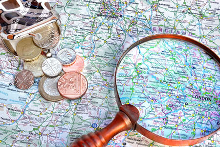 Map of England, vintage magnifying glass and small purse with English coins