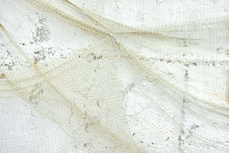 Old Fishing Net on White Wall Backgroundの写真素材