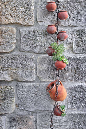 Hanging Clay Jugs with Plants. Background and Texture for text or image
