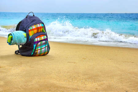 Travel Backpack with Towel on Summer Sea Beach. Holiday and Vacation Symbolの写真素材