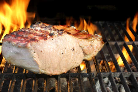 Pork Ribs on Flaming BBQ Grillの写真素材