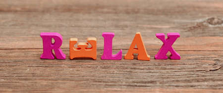 Sign Relax Made From  Wood Letters on the Grunge Wooden Boardの写真素材