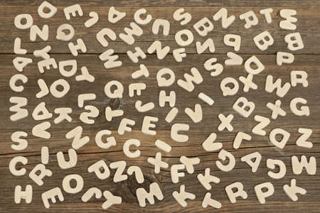 Many English Wooden letters Scatterd on The Grunge Timber Tableの写真素材