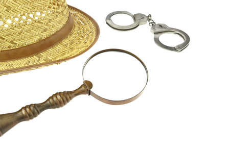 Retro Straw Hat, Magnifying Glass and Handcuffs  Isolated on White Backgroundの写真素材