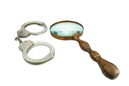Retro Magnifying Glass and Handcuffs isolated on White Backgroundの写真素材